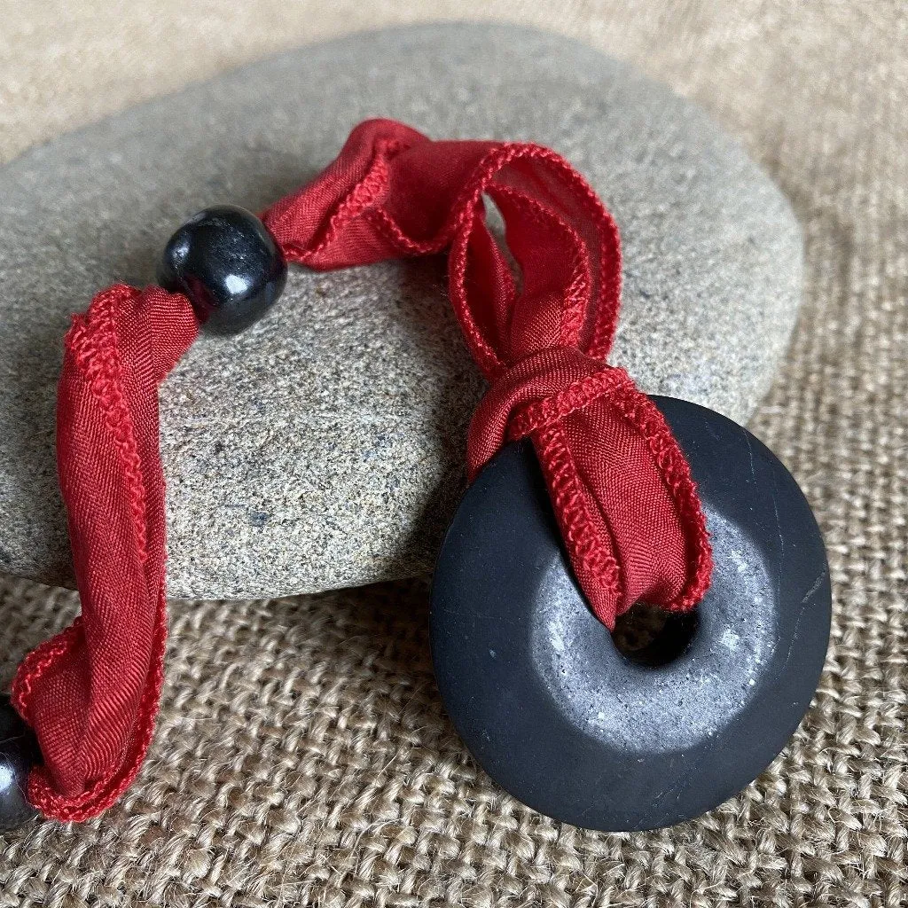 Shungite Donut Pendant on Red Silk